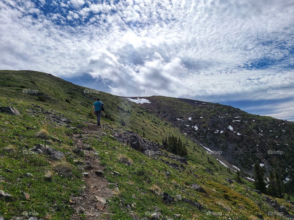 Scattered white clouds over the ridge