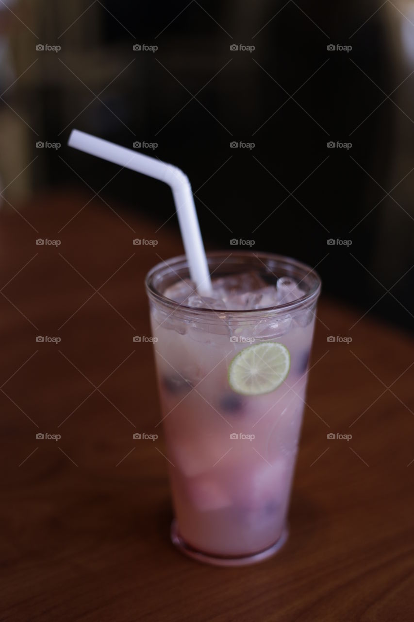 close up selective focus of a refreshing iced cold fruity drink served on a table