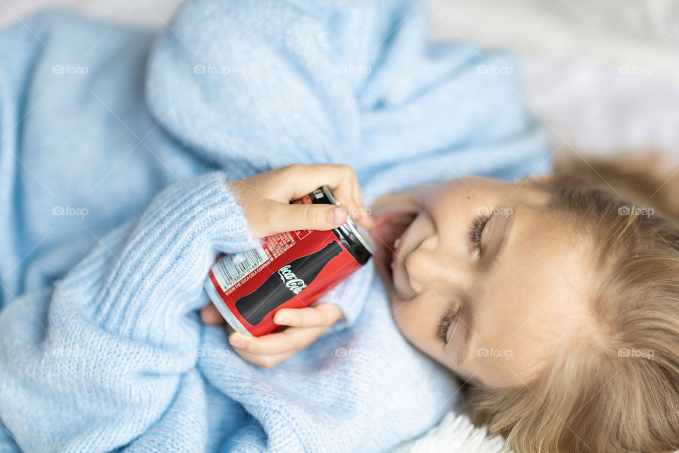 Kid holding Coca Cola can