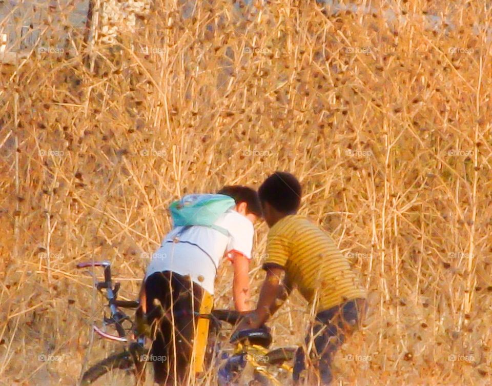Two children and a bicycle