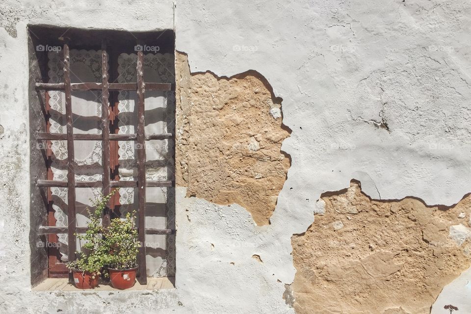 Rustic window on an old white house