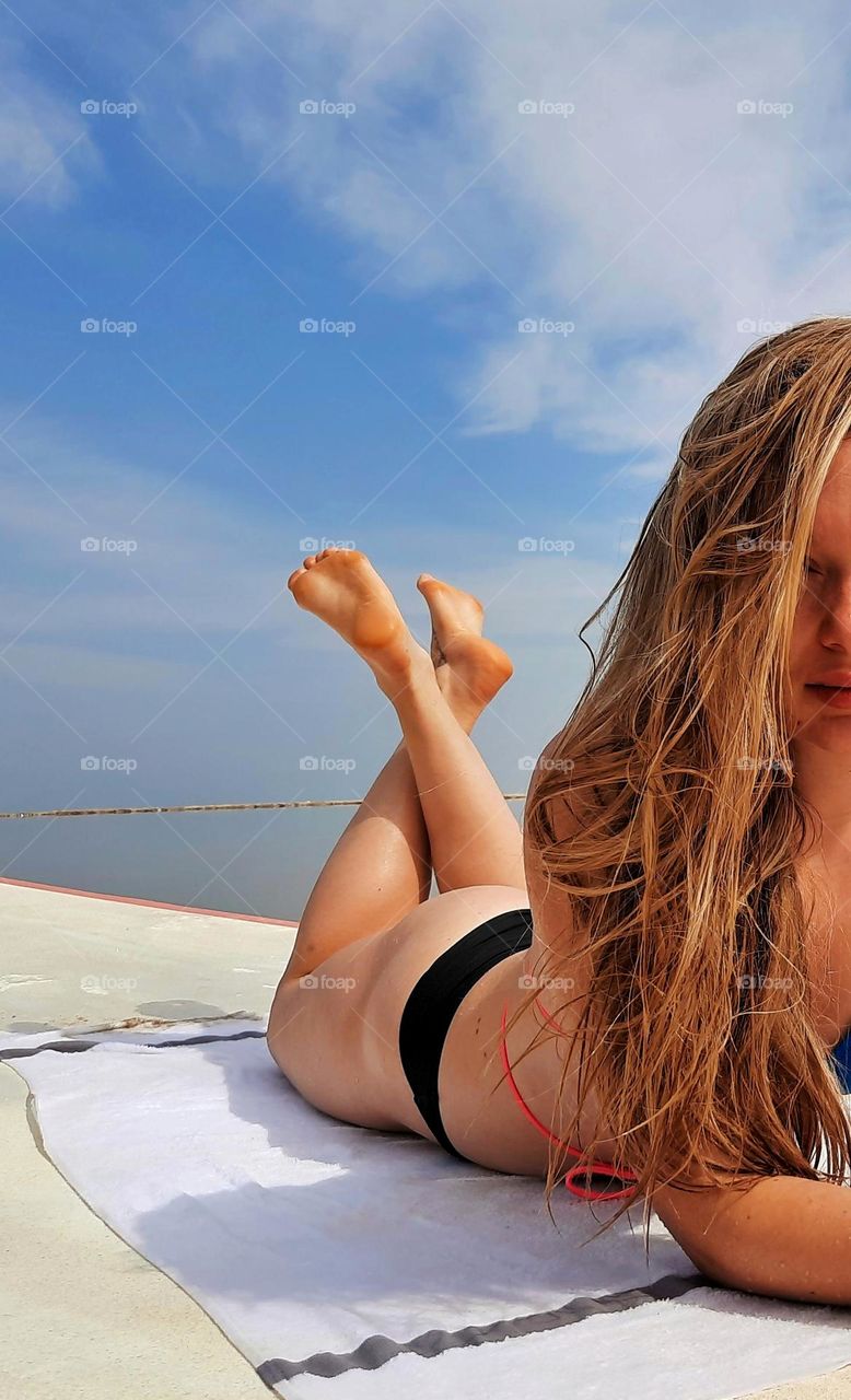 sunbathe on the beach