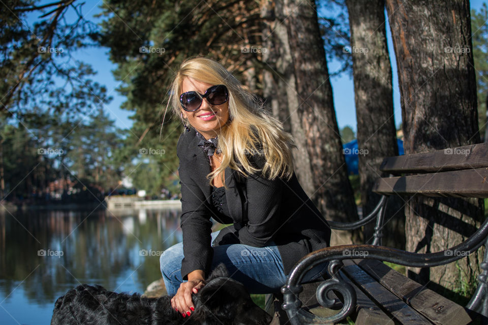 Young girl with blond hair. Photographed in a park. Nature background