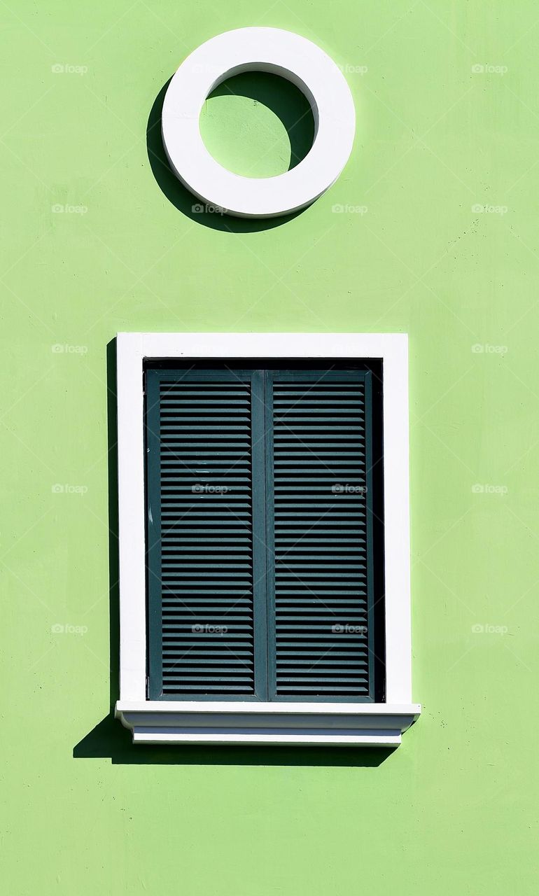 Window on a green wall 