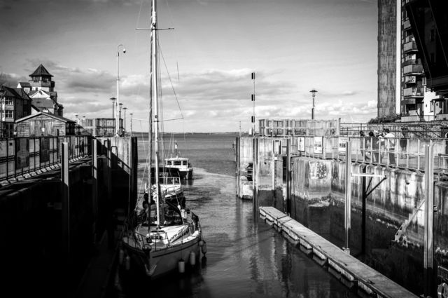 Sailboats moored at port