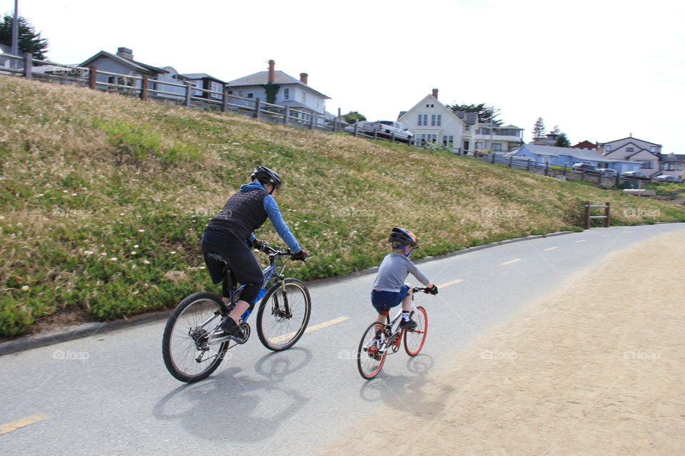 Adult and child riding bicycles 