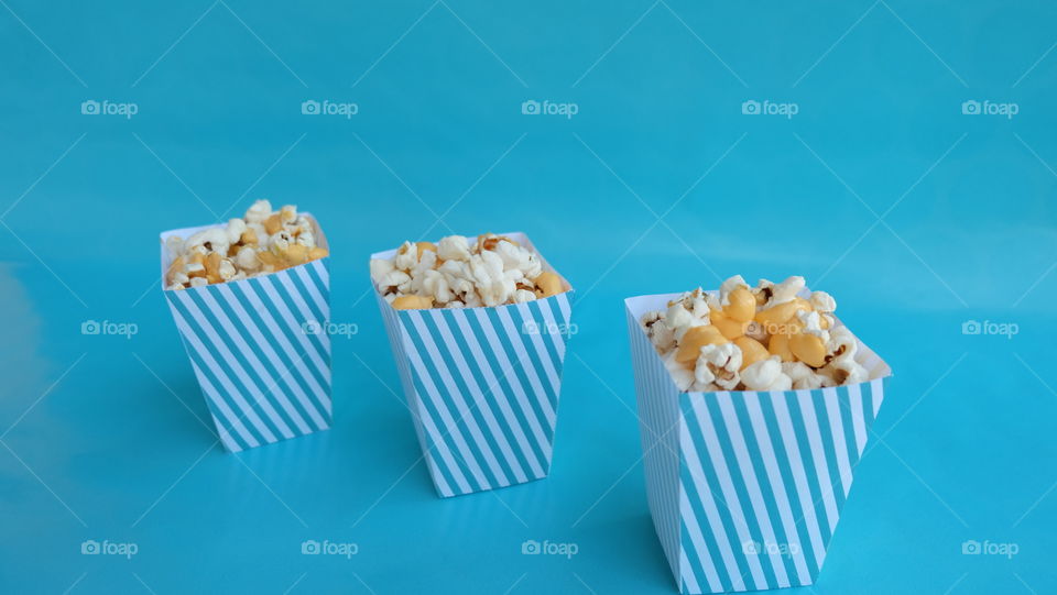 Popcorn boxes on blue background