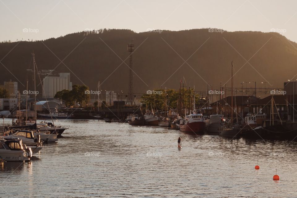 Distant view of woman paddleboarding on sea