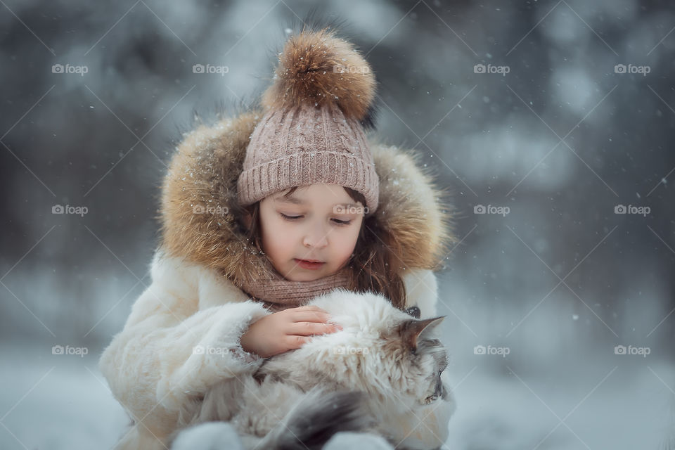 Little girl portrait with cat, winter outdoor 