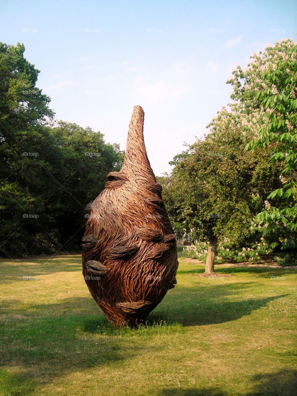 a strange plant statue in a park