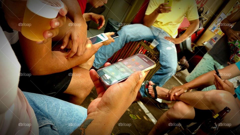 Reunião de amigas com celulares, tomando cerveja.