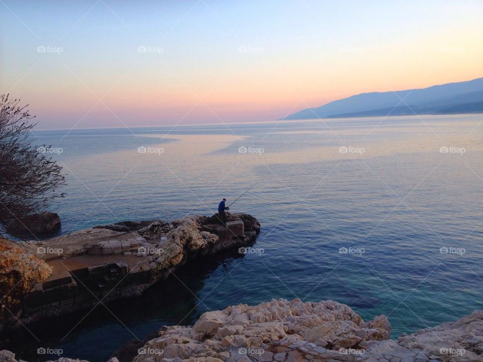 A person fishing in sea