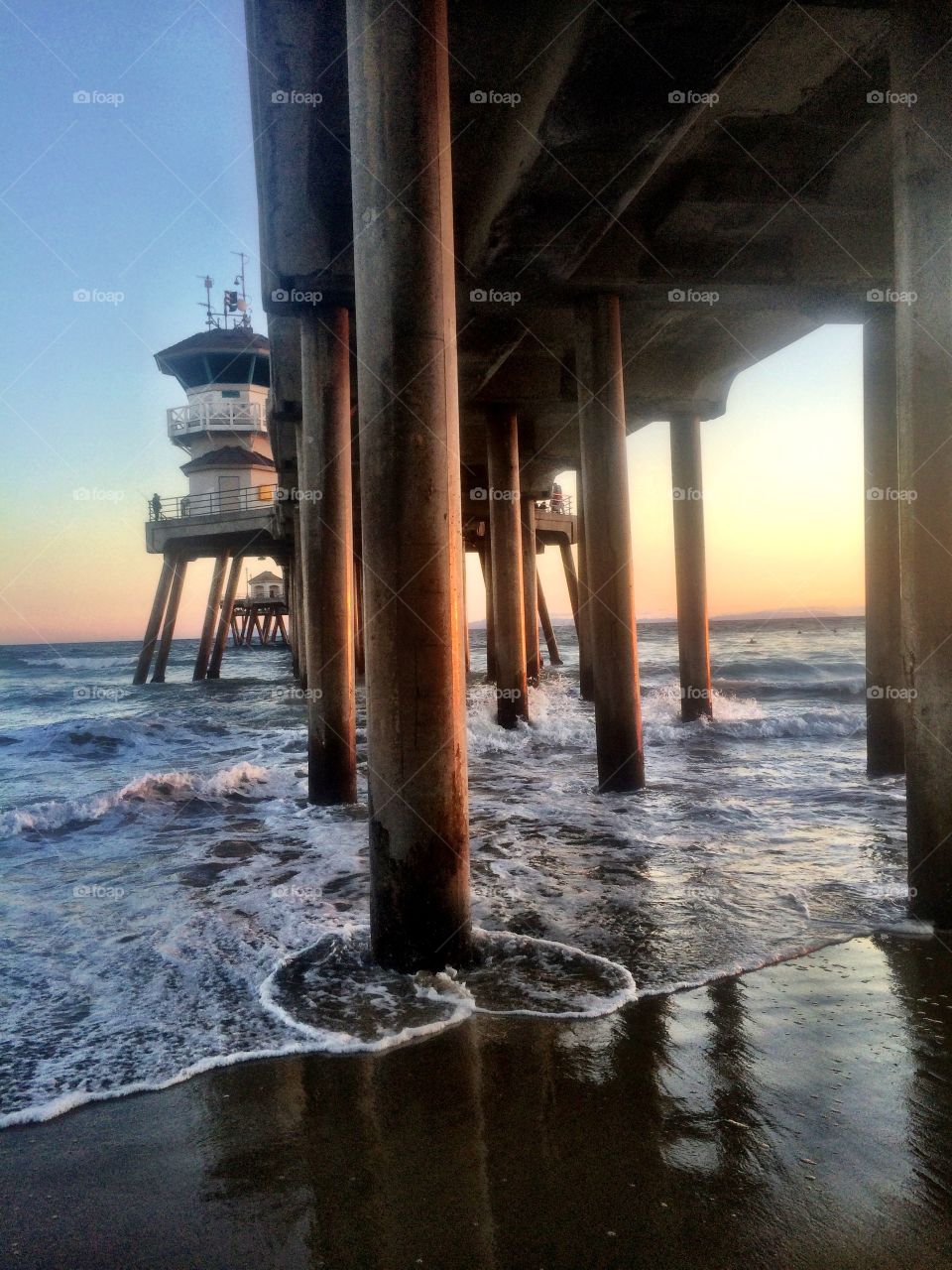 Summer under the pier. Huntington Beach Pier at sunset