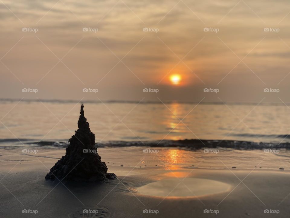 Capture the mesmerising beauty of nature with this stunning sunset view photography in the sea. The captivating image showcases the vast expanse of the sea, adorned a breathtaking palette of orange.