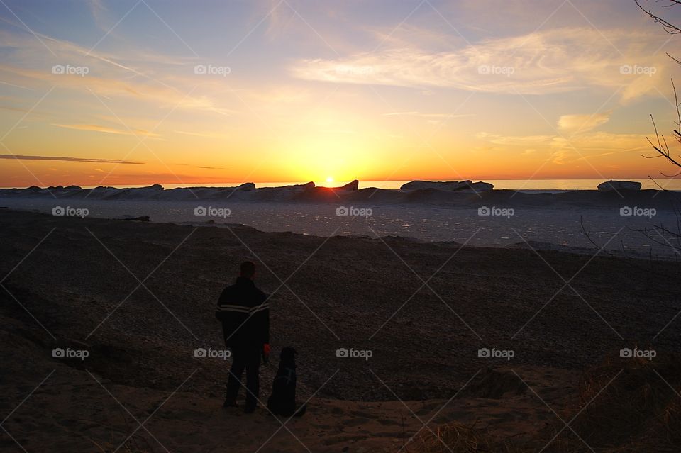 Rear view of people standing on beach 