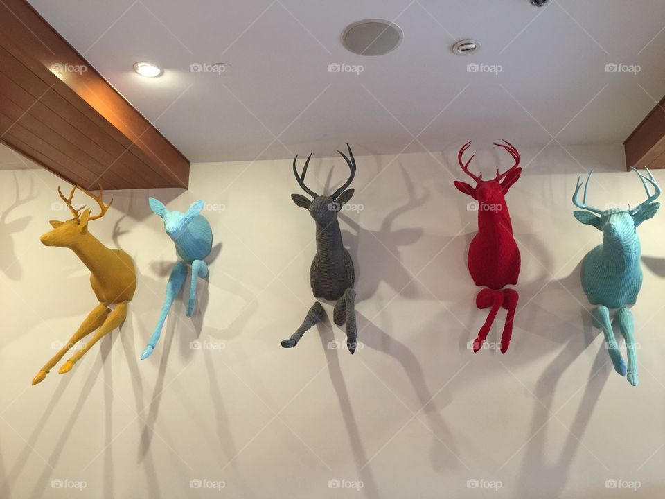 Local art of different colours hanging off the wall in Nitka Lake restaurant in Whistler, British Columbia