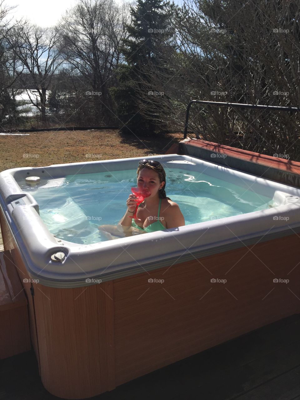 Woman drinking martini in small pool