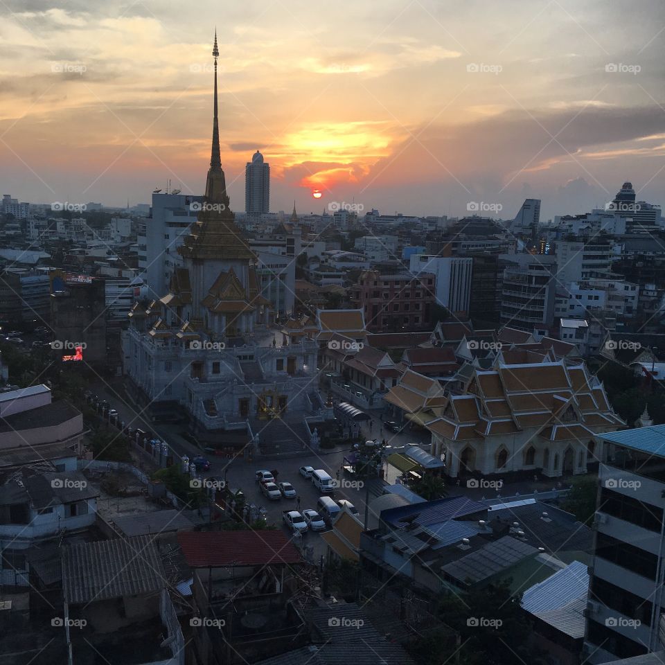 The sun setting on the golden Buddha 