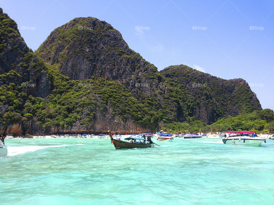 Picturesque beach landscape with local boats at Phi-Phi island in Thailand 