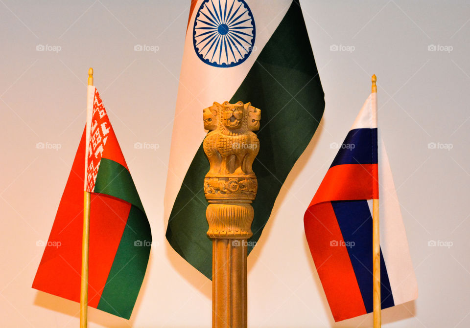 This picture displays the friendship among the three countries and one can see the National Emblem of India nicely carved on a wooden log by a carpenter which displays four lions roaring in front of the Indian flag at the centre. 