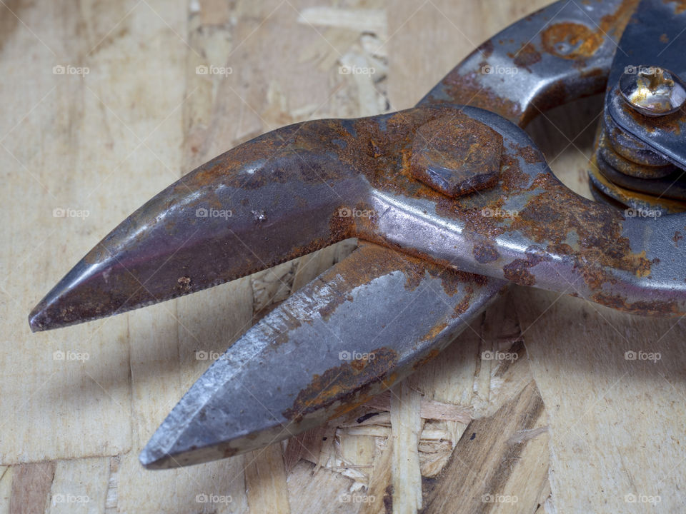 Old, rusty scissors on iron