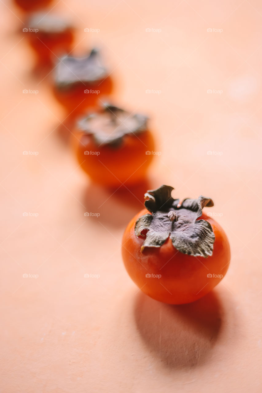 Bright persimmon on the beige background 