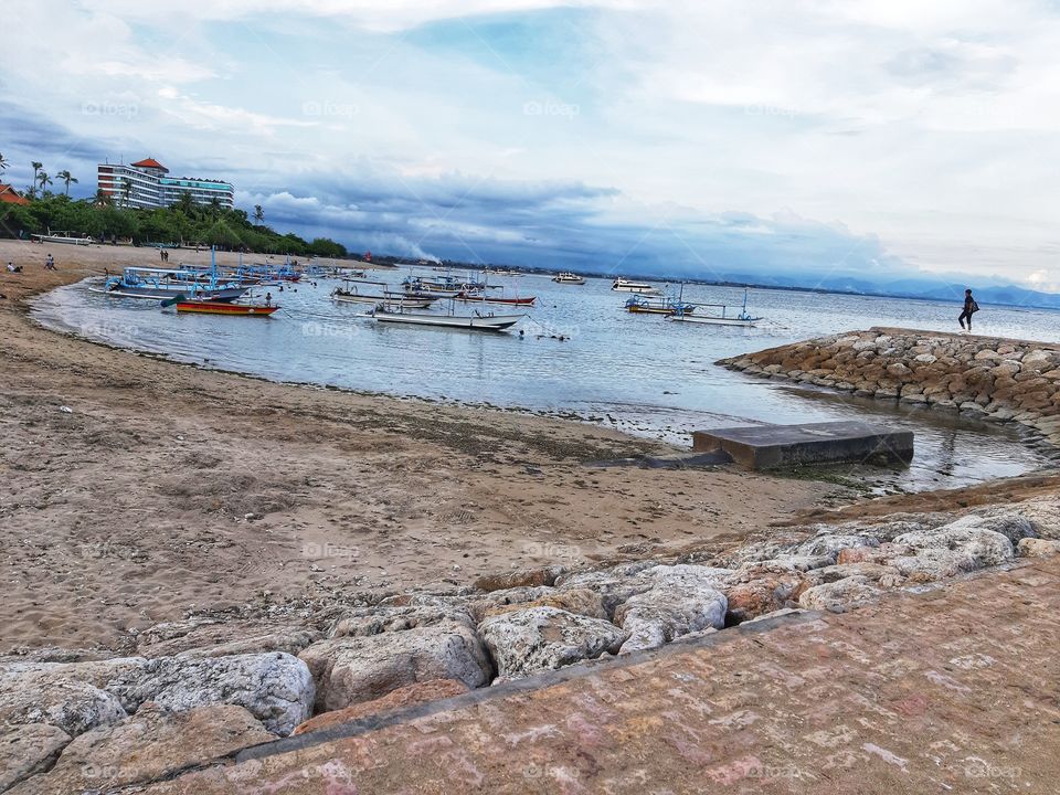 This is a photo of a Sanur beach view that is located in Bali. It can be seen that the beach is so peaceful where only few tourists come because of the pandemic of Covid -19.