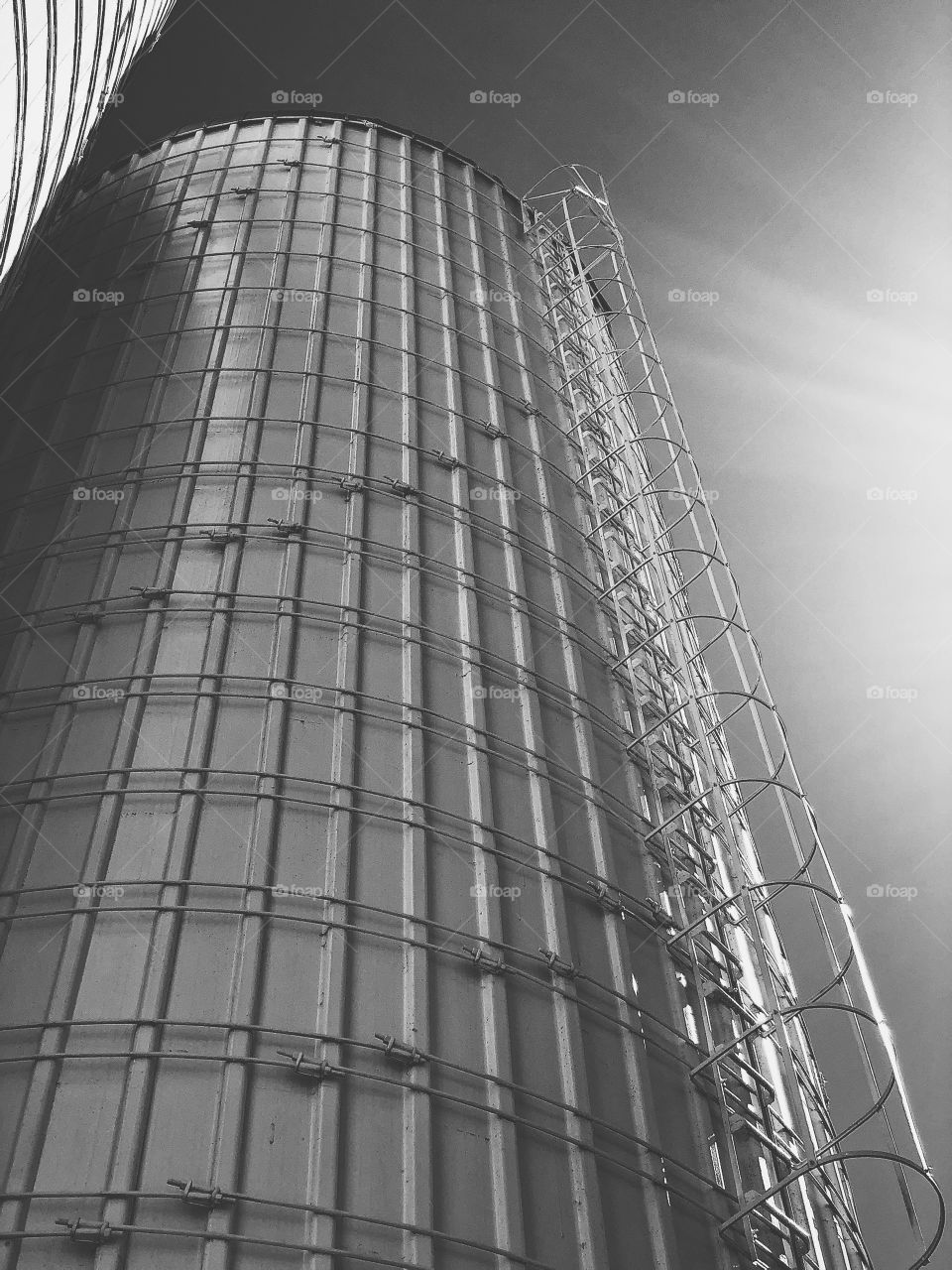 Monochromatic photo of a silo, black and white silo, tall silo in the sunlight, side lighting on a tall silo, monochrome buildings, monochromatic country side