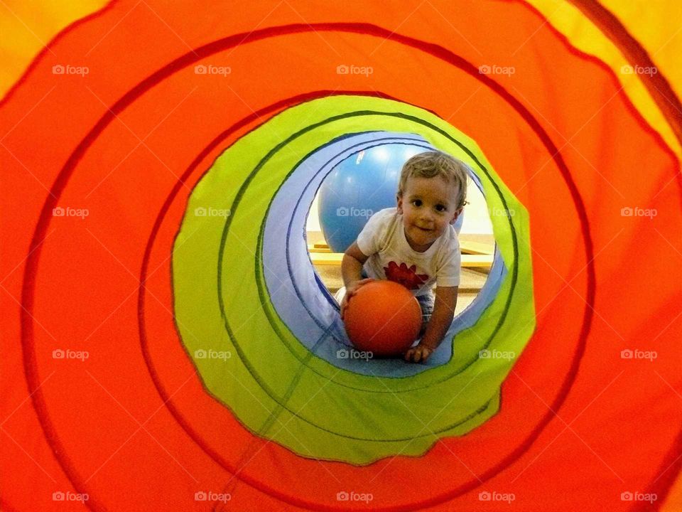 Boy in garden playing with ball