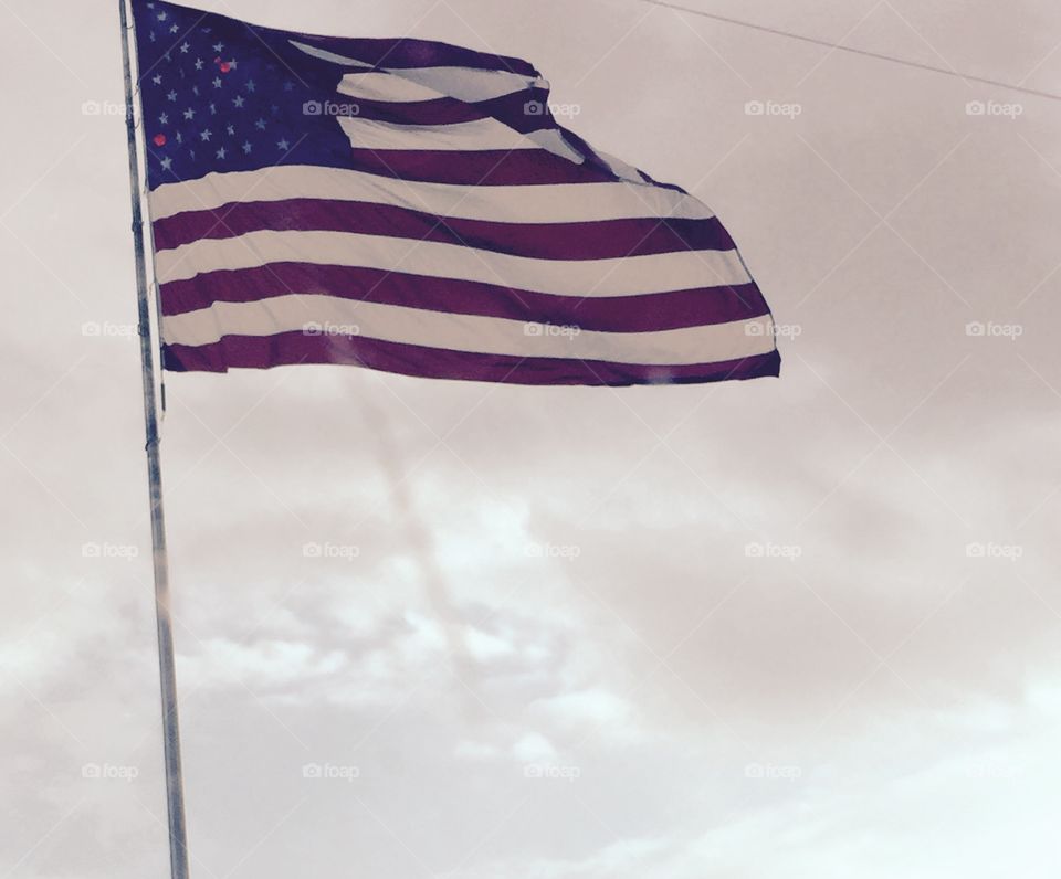 Our beautiful American Flag blowing in the wind in the sky in state if Virginia.