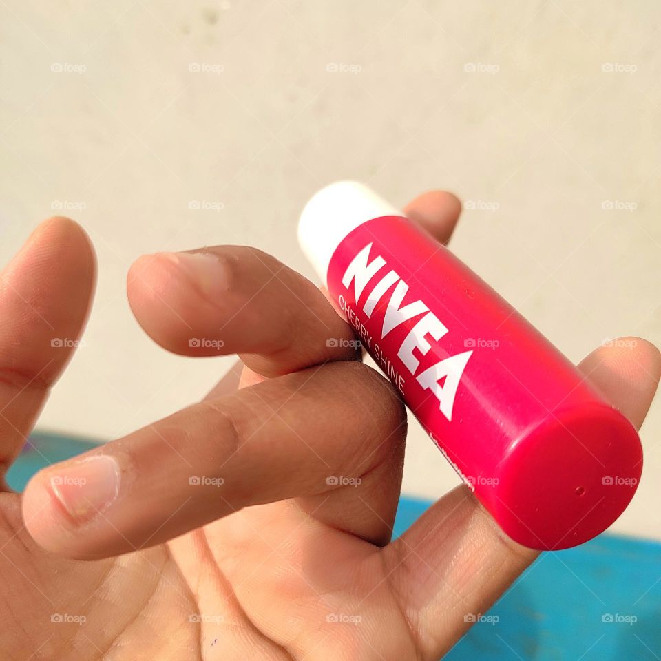 A beauty product lip care in hand