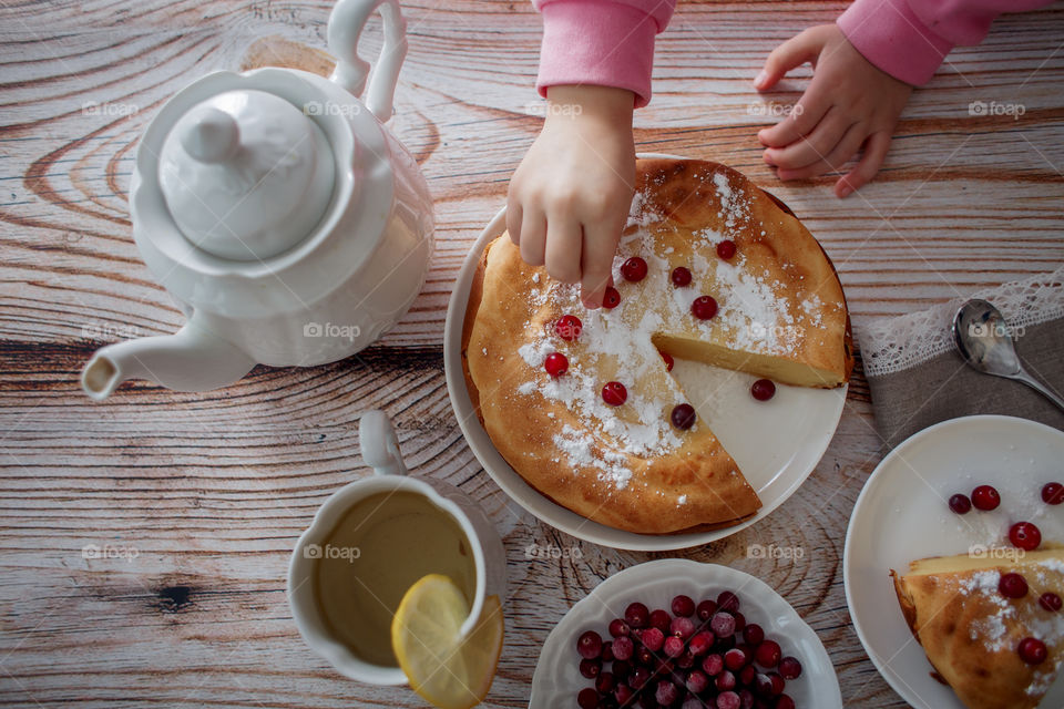 Children breakfast with cheesecake. Hands, detail