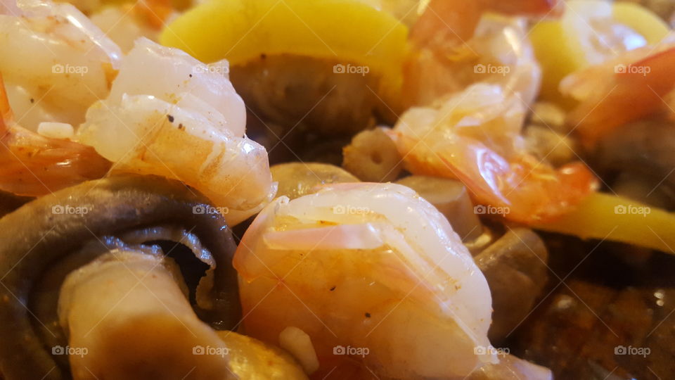Boiled cajun shrimp with mushrooms and corn