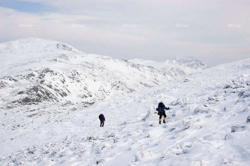 Backpackers crossing the frozen tundra in the high summits of the