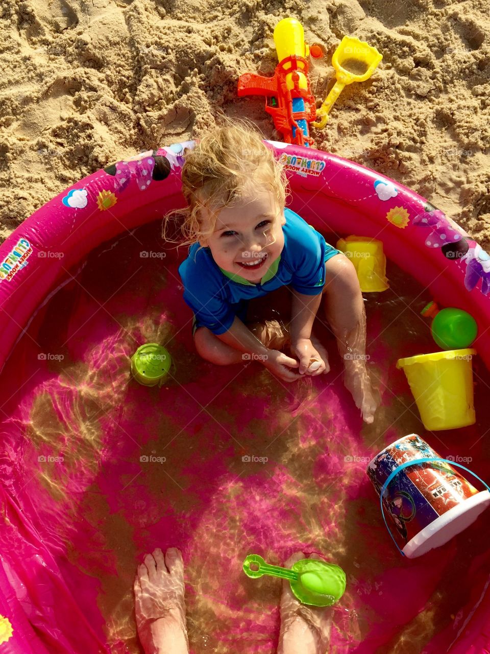 Elevated view of a little girl playing in inflatable pool