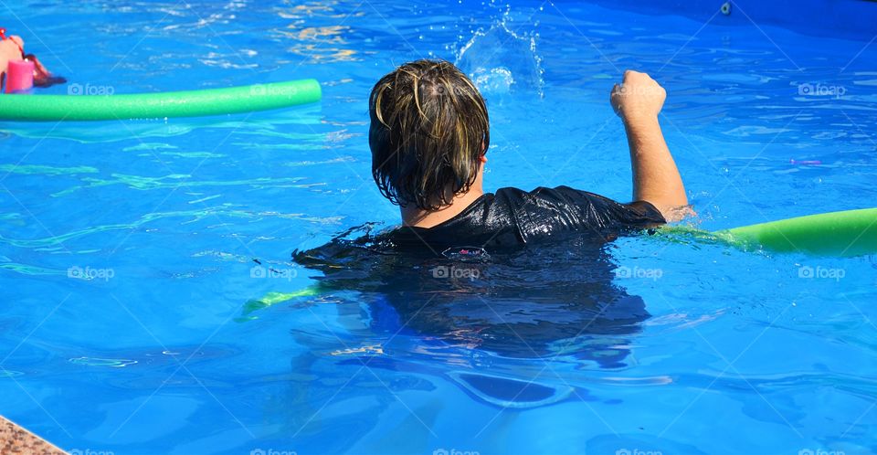 Man in swimming pool. Young man in swimming pool