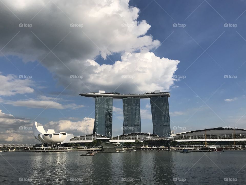 Stormy clouds resting on iconic Singapore building ..