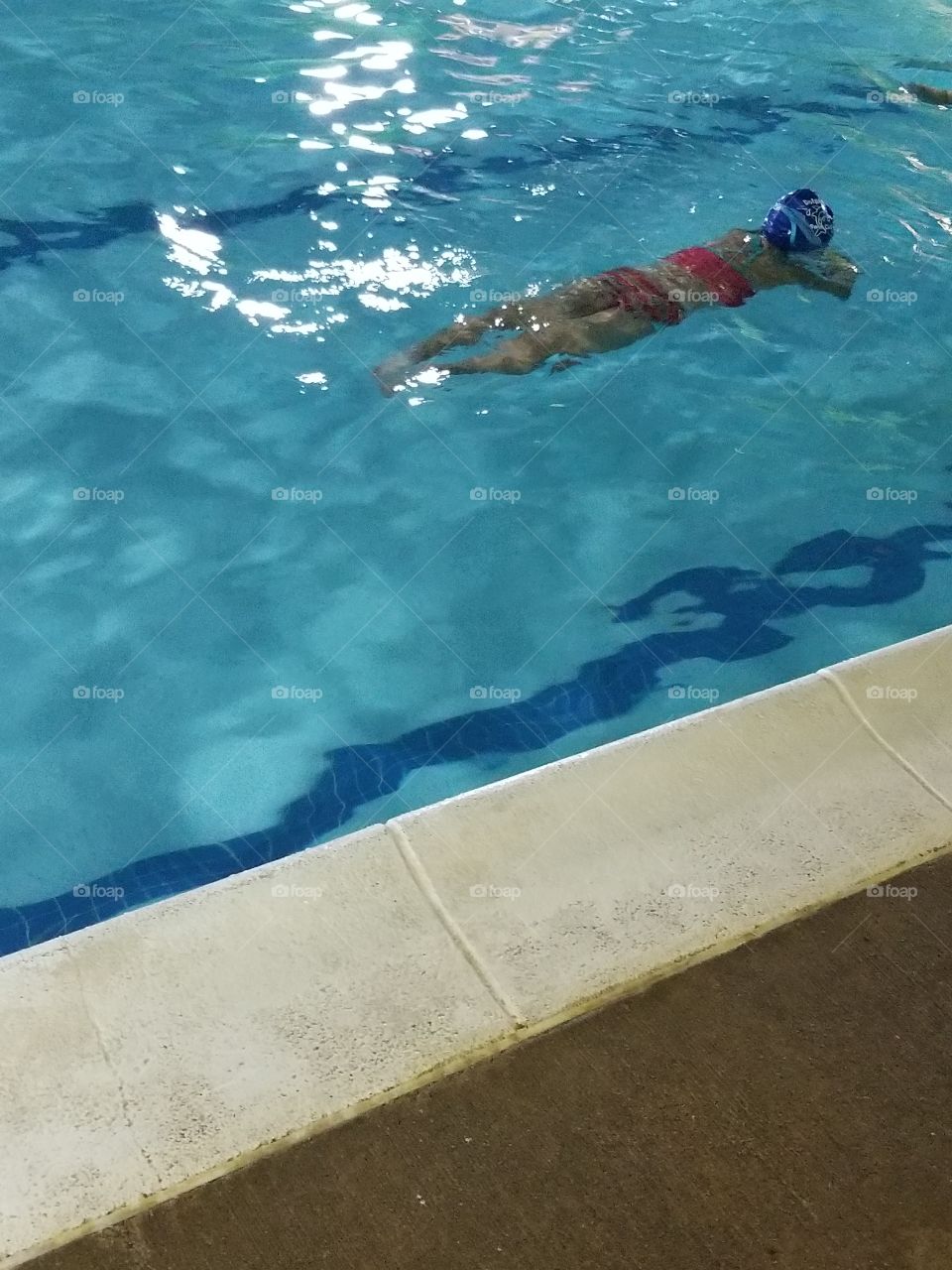 child swimming in pool