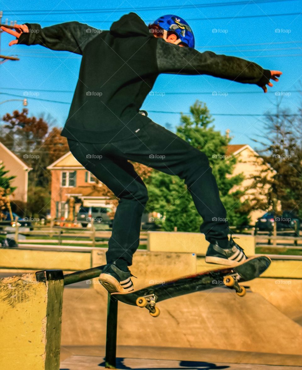 Boy on a skateboard doing a trick.