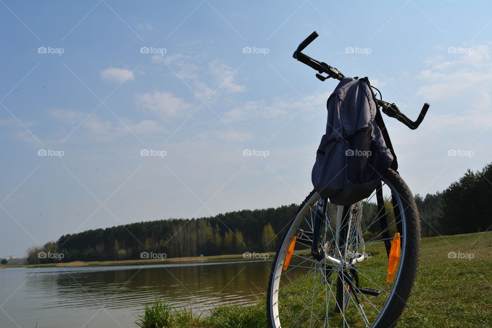 bike on a lake shore beautiful spring landscape blue sky background