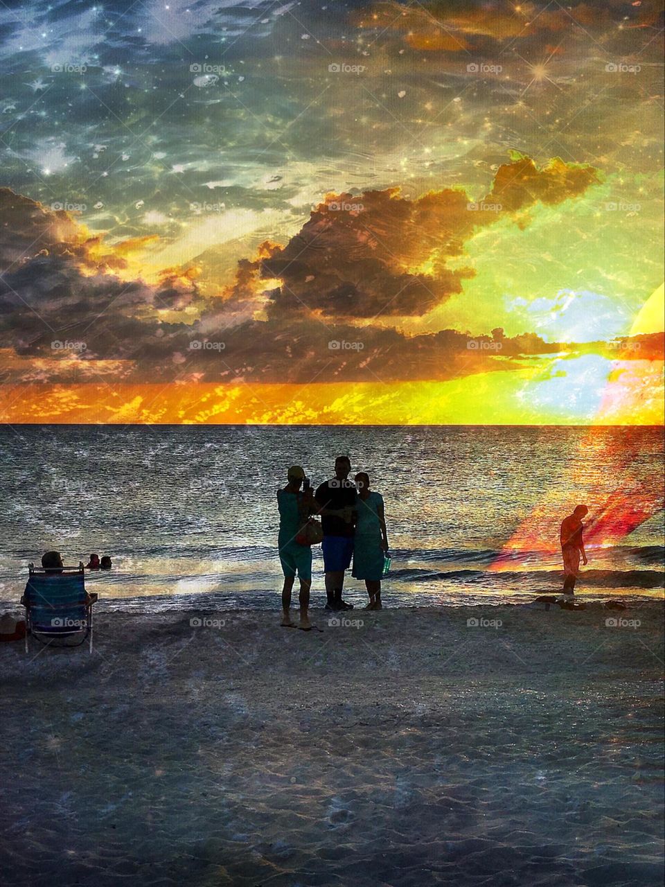 Spectacular ocean sunset with people and special visual elements .