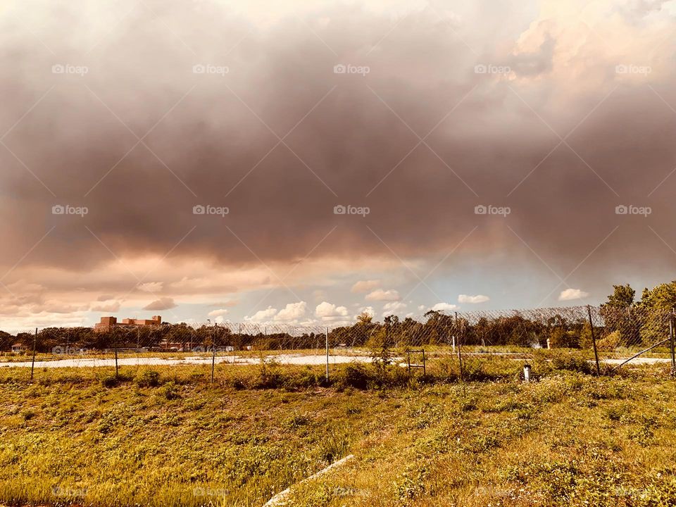 Fire Cloud Above Plain Field Meadow With Forest In The Background