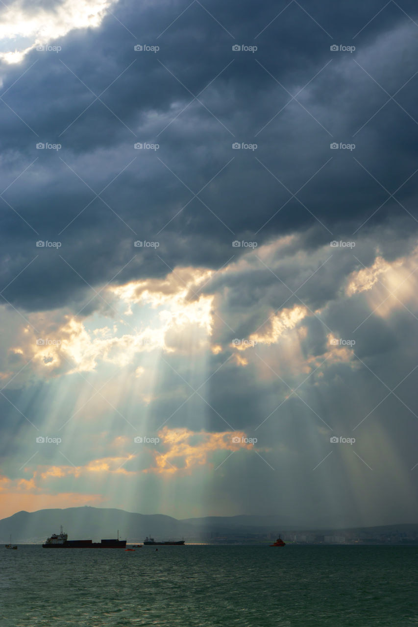 Illumination sunrays on the beach Black sea