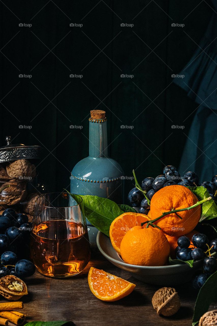 still life with tangerines, grapes and nuts