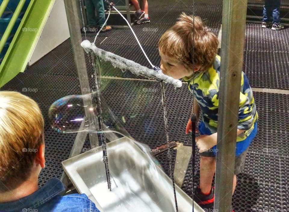 Boy Blowing A Giant Bubble. Little Boy On A Kindergarten Field Trip To A Science Museum
