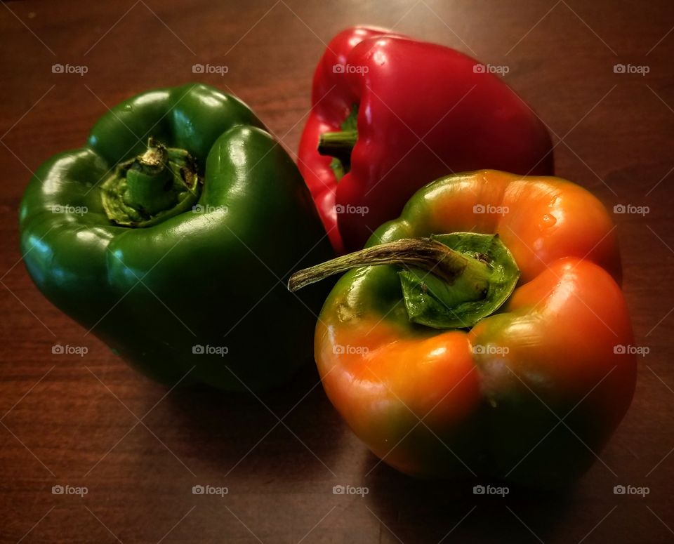 Still Life of Three Bell Peppers in Green, Red and Orange
