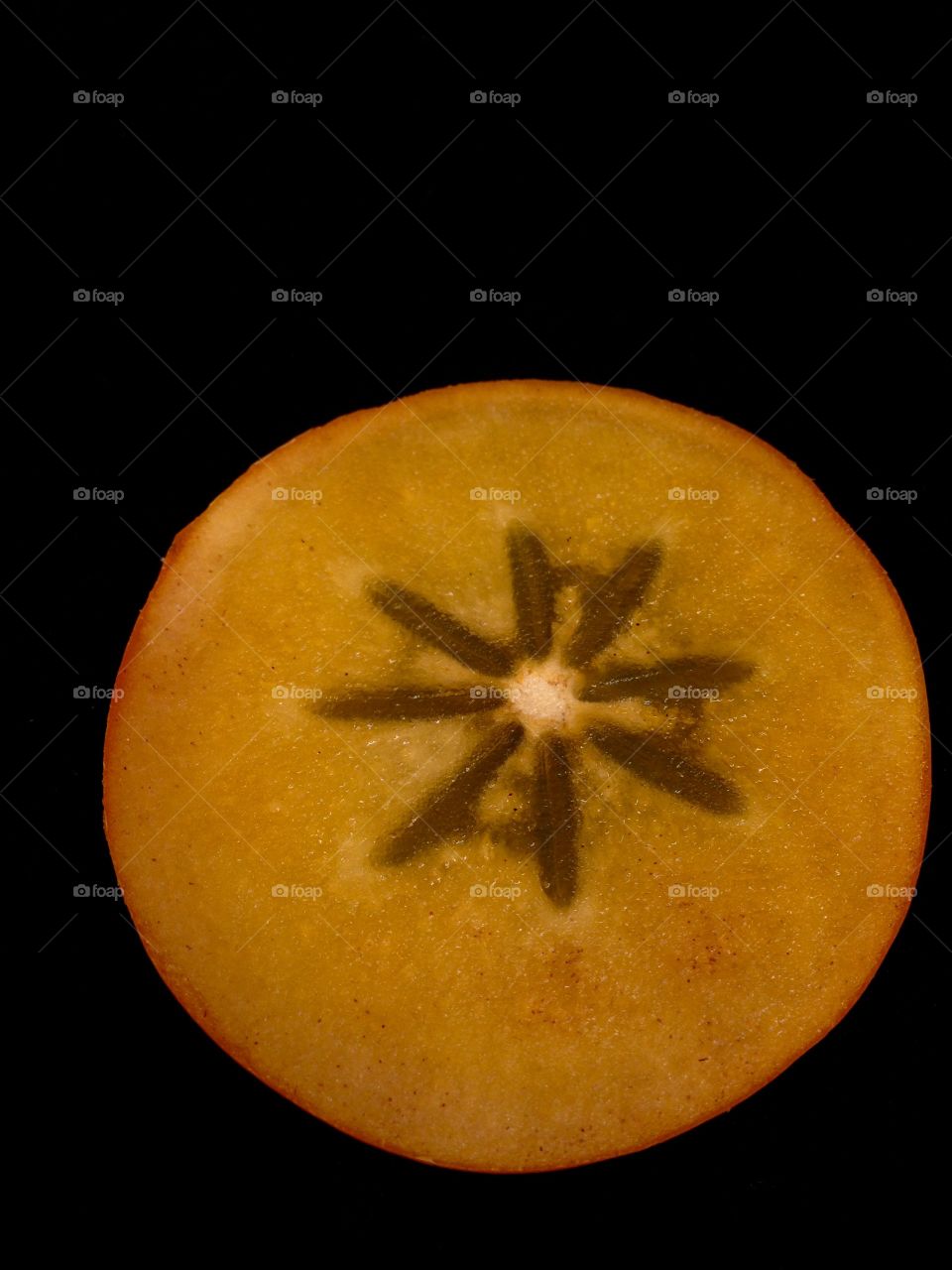 One slice of persimmon on black 