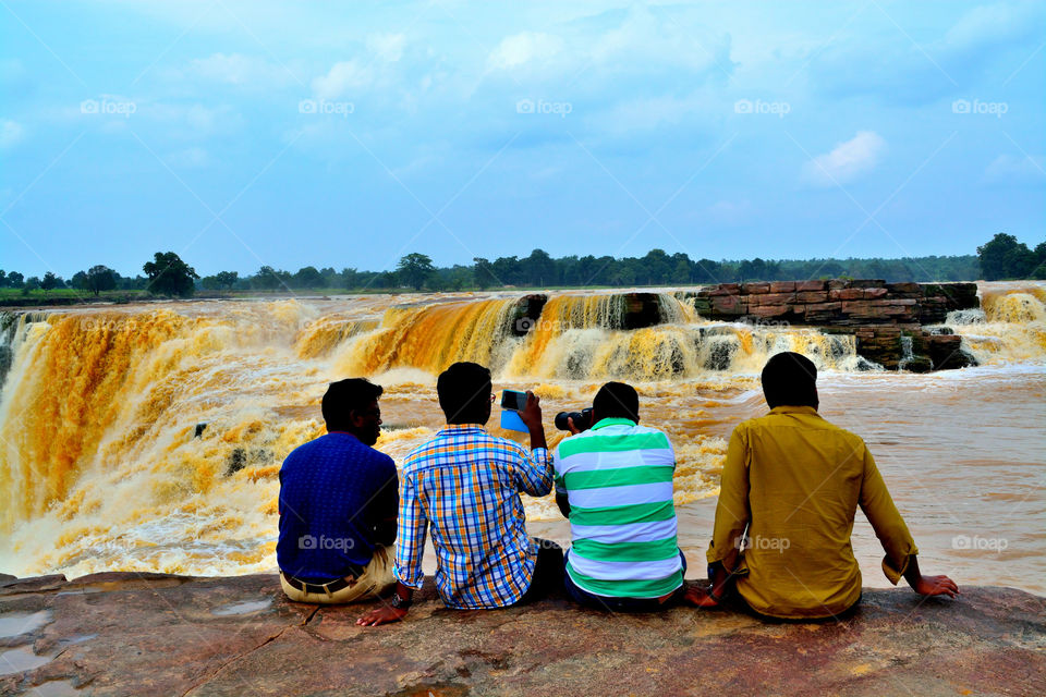 people enjoying waterfall