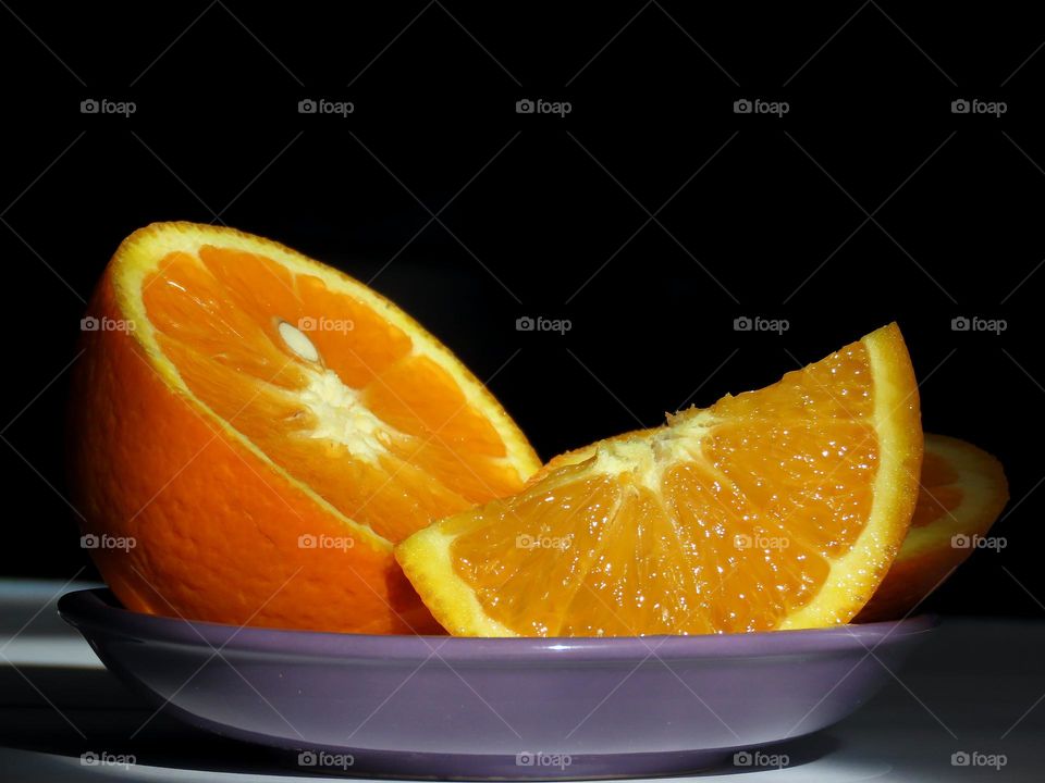 Orange on a lilac saucer