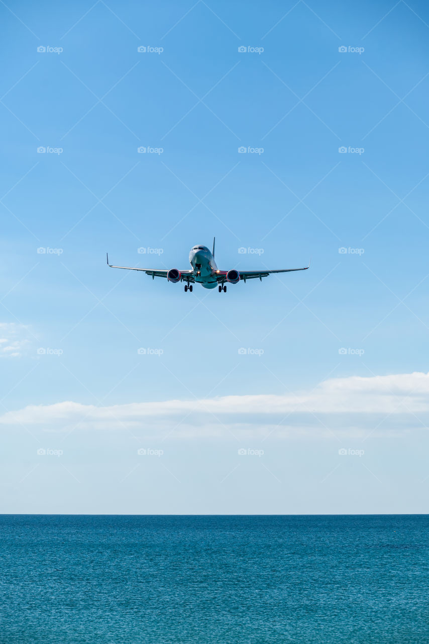 Airplane landing into port at Beautiful sea scape view in the southern of Thailand